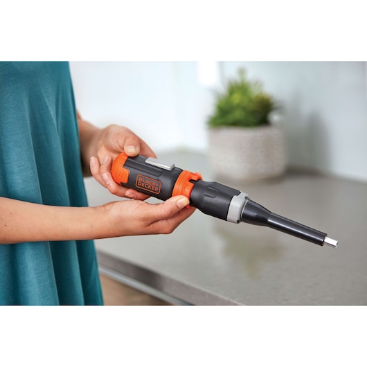 Photo of BLACK+DECKER BCF601AA cordless screwdriver with orange and black design, held in hands indoors.