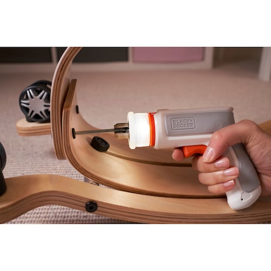 Photo of BLACKDECKER BCRTA01 cordless screwdriver with LED light assembling wooden furniture.
