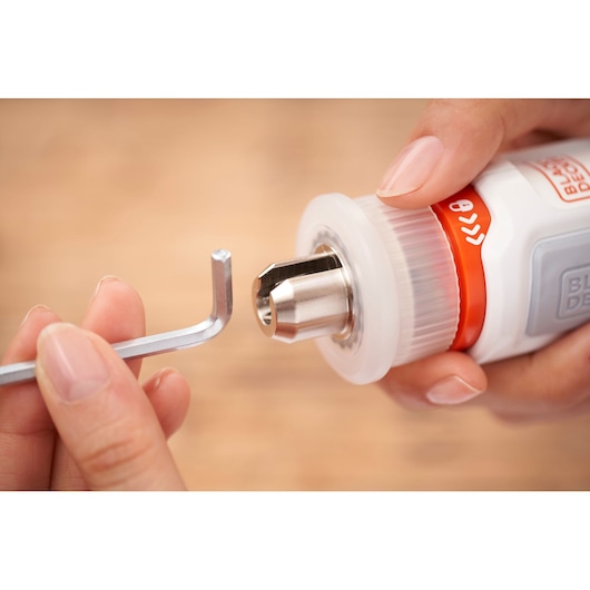 Close-up photo of BLACKDECKER BCRTA01 tool with hex key being inserted into metal chuck.