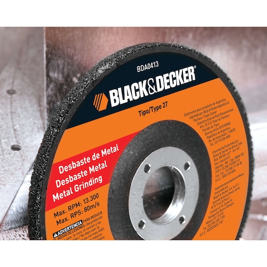BLACK+DECKER BDA0413 metal grinding disc, close-up of edge and label, orange and black design, text in multiple languages.