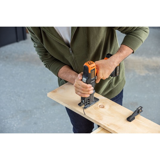 Photo of BLACKDECKER BDCDMT1206KITC cordless power tool being used to cut a wooden board.