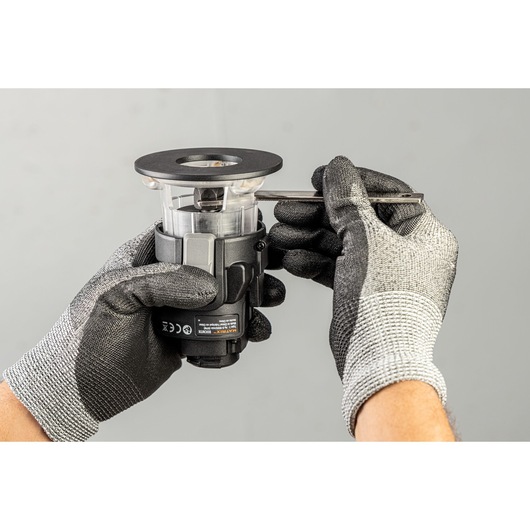 BLACKDECKER BDCDMT1206KITC power tool attachment held by gloved hands, side angle.
