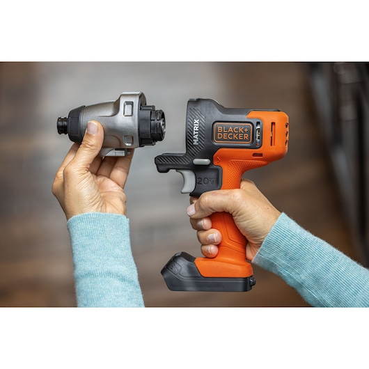 Photo of BLACK+DECKER BDCDMT1206KITC cordless drill with orange and black body, shown with detachable drill attachment.