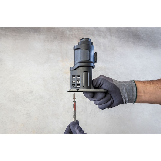 BLACKDECKER BDCDMT1206KITC reciprocating saw attachment held in gloved hands, side angle.
