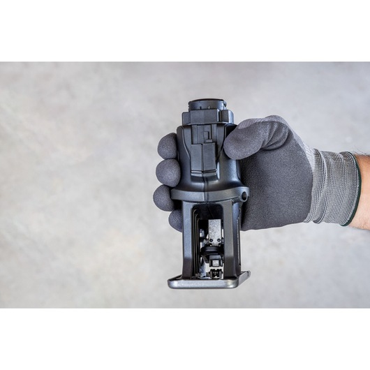Photo of a BLACKDECKER BDCDMT1206KITC tool attachment held in a gloved hand, close-up view.
