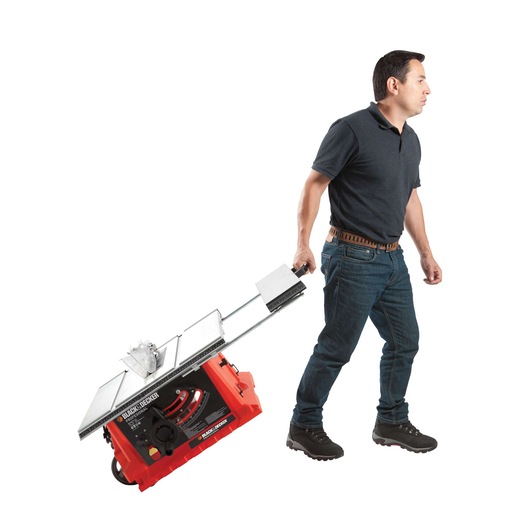 Photo of person pulling BLACK+DECKER BDTS1800 portable table saw by handle, white background, side angle.