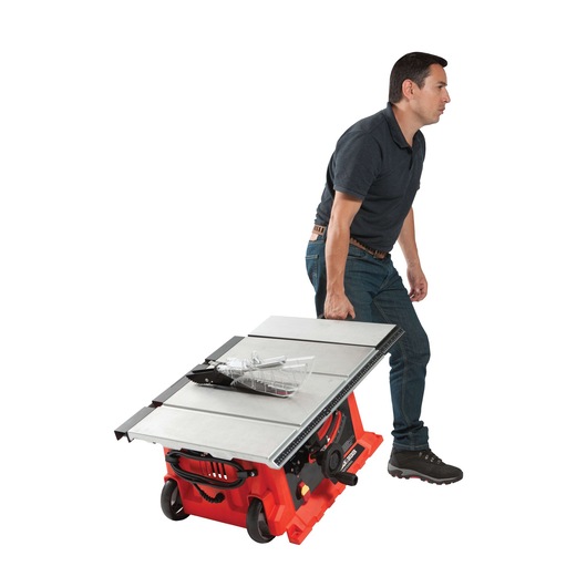 BLACKDECKER BDTS1800 portable table saw with wheels being pulled by a person, side angle, white background.