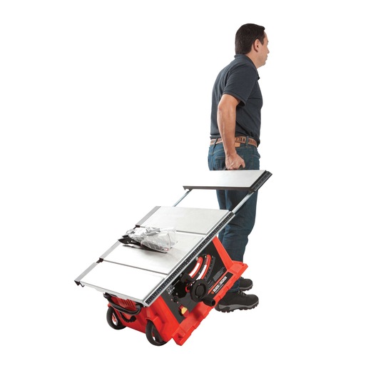 Photo of a man pulling a BLACKDECKER BDTS1800 portable table saw with red base and wheels on white background.