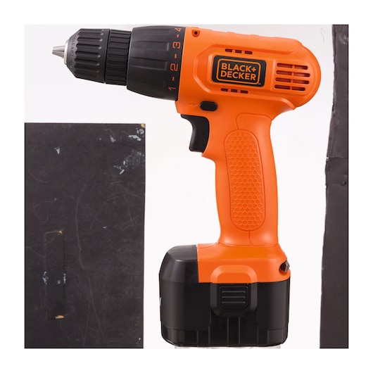 BLACK+DECKER cordless drill CD121K100 side view, orange and black color, textured grip, white background.