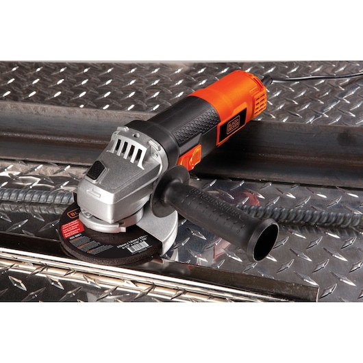 BLACKDECKER G720 angle grinder with black and orange handle on metal surface, close-up view.