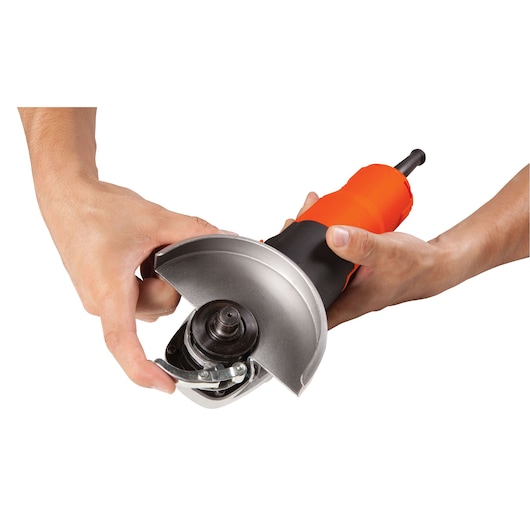 Photo of BLACKDECKER G720 angle grinder being adjusted, showing guard and spindle, front angle.