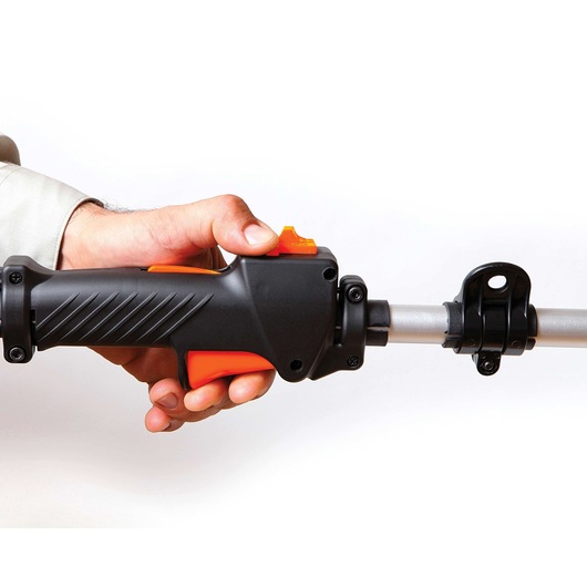 Photo of BLACKDECKER GST26 trimmer handle close-up, showing ergonomic grip and orange trigger on white background.