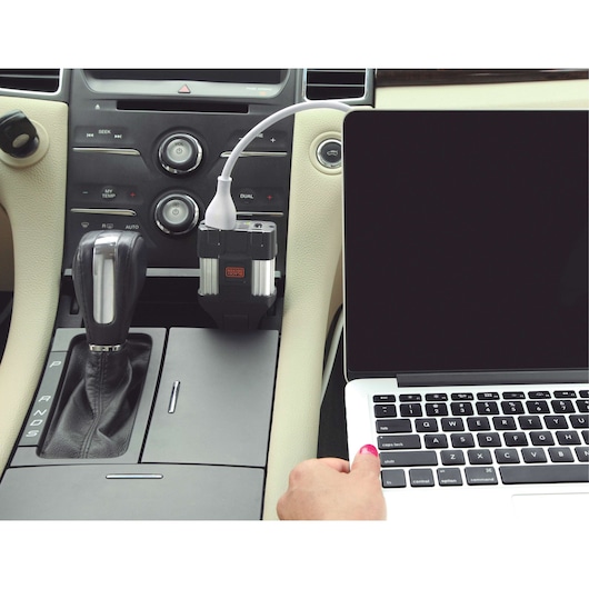 BLACKDECKER PI100LA car power inverter plugged in, USB cable charging a laptop in vehicle interior.